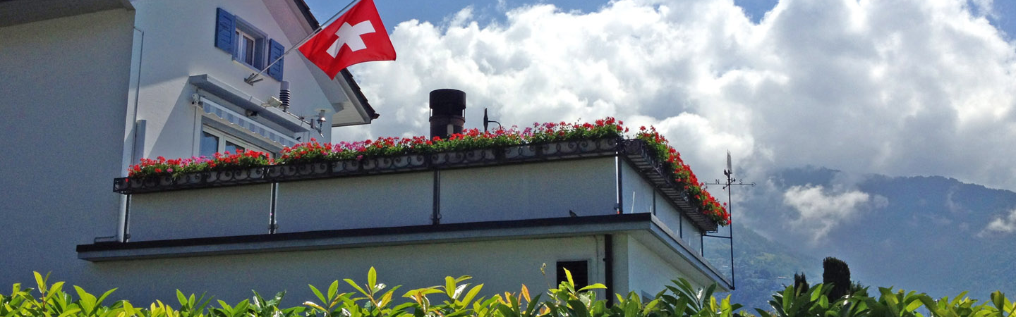 Swiss flag flying over a house