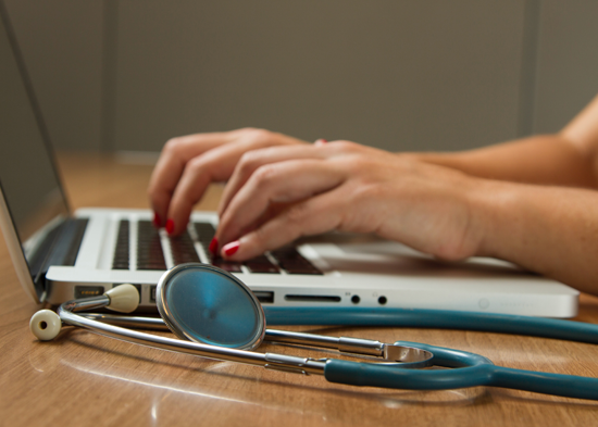 Woman medical professional on a computer