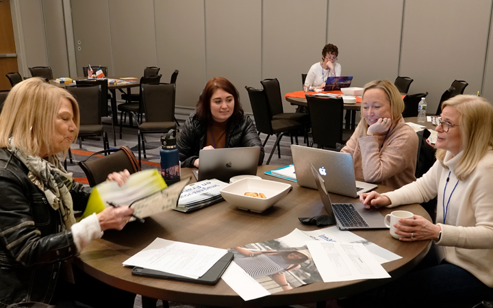 Women at a table with computers