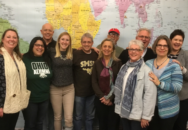 Group of people in front of map