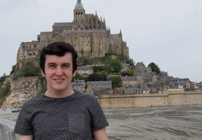 Boy with fortress behind