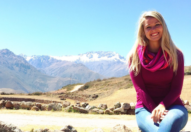 Woman sitting with mountains behind