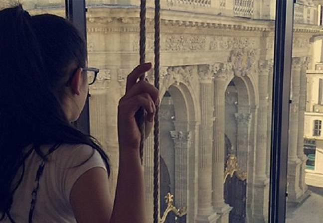 Girl looking out window