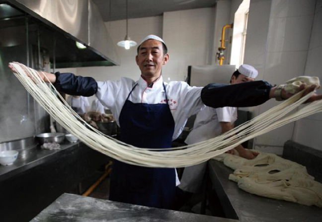 Man pulling noodles