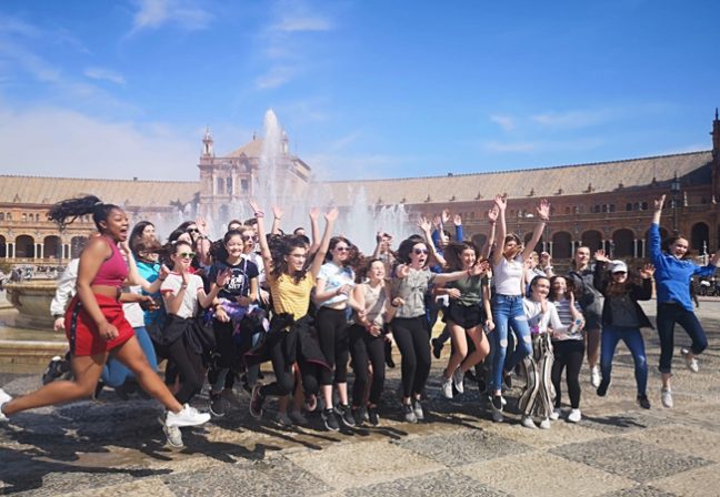 Student group jumping in front of the Plaza Mayor