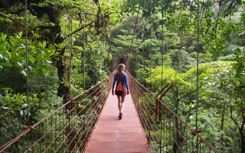 Girl Walking on Rope Bridge in Costa Rica