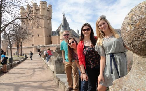 4 Smiling People at Alcazar Segovia Spain