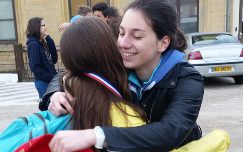 Student and host sister greet