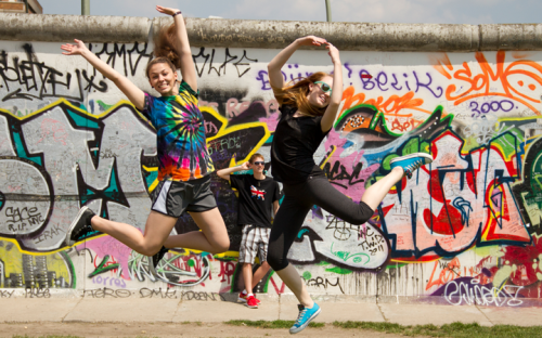 Two students dancing at the Berlin Wall 