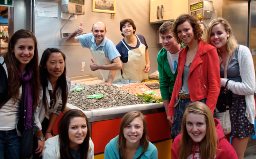 Group of students with a market vendor