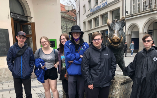 Student group next to a statue of a boar