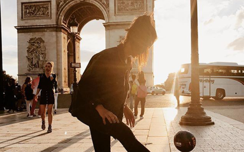 Girl playing ball at the Arc de Triomphe