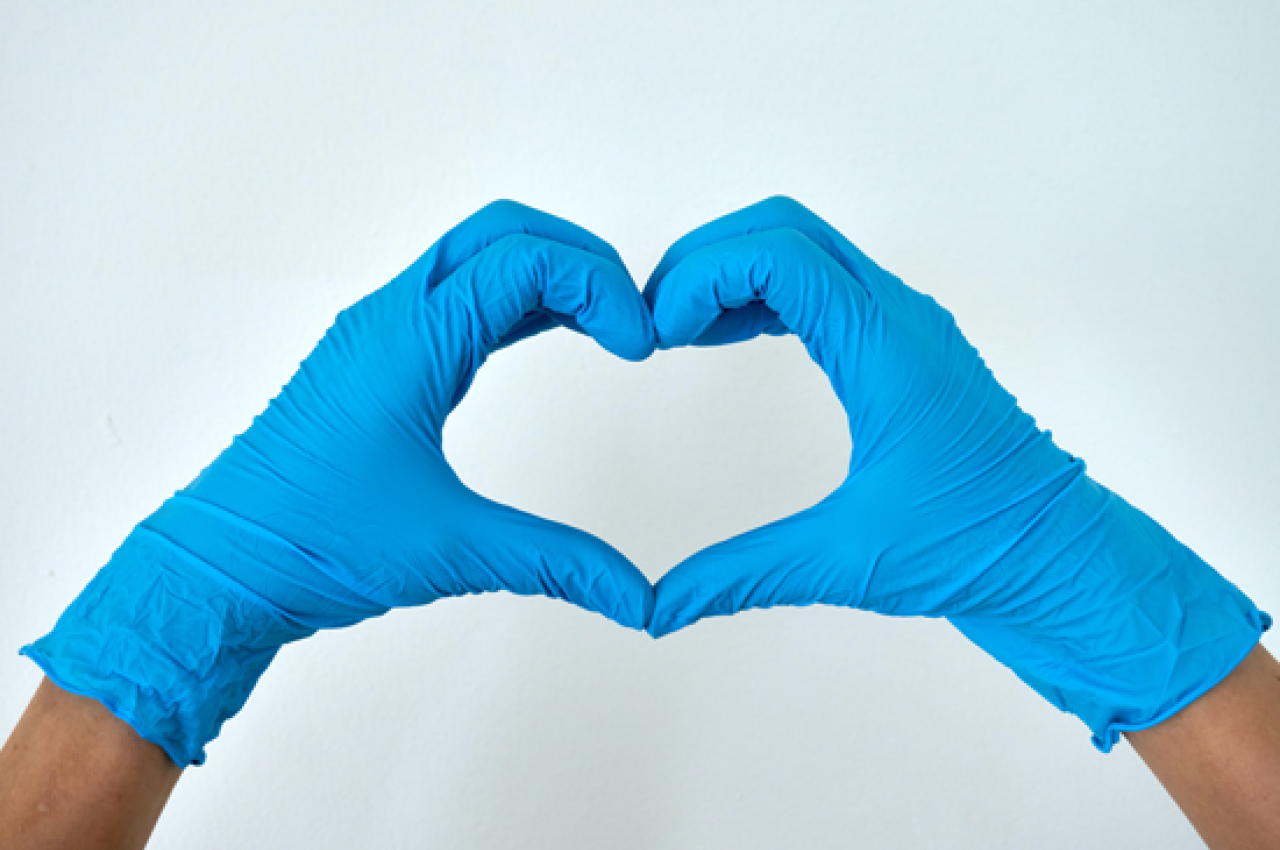 Hands with medical gloves making a heart