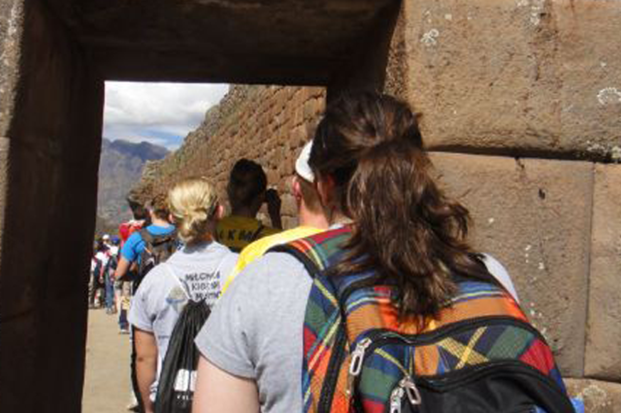 Students walking through stone door in Pisac ruins