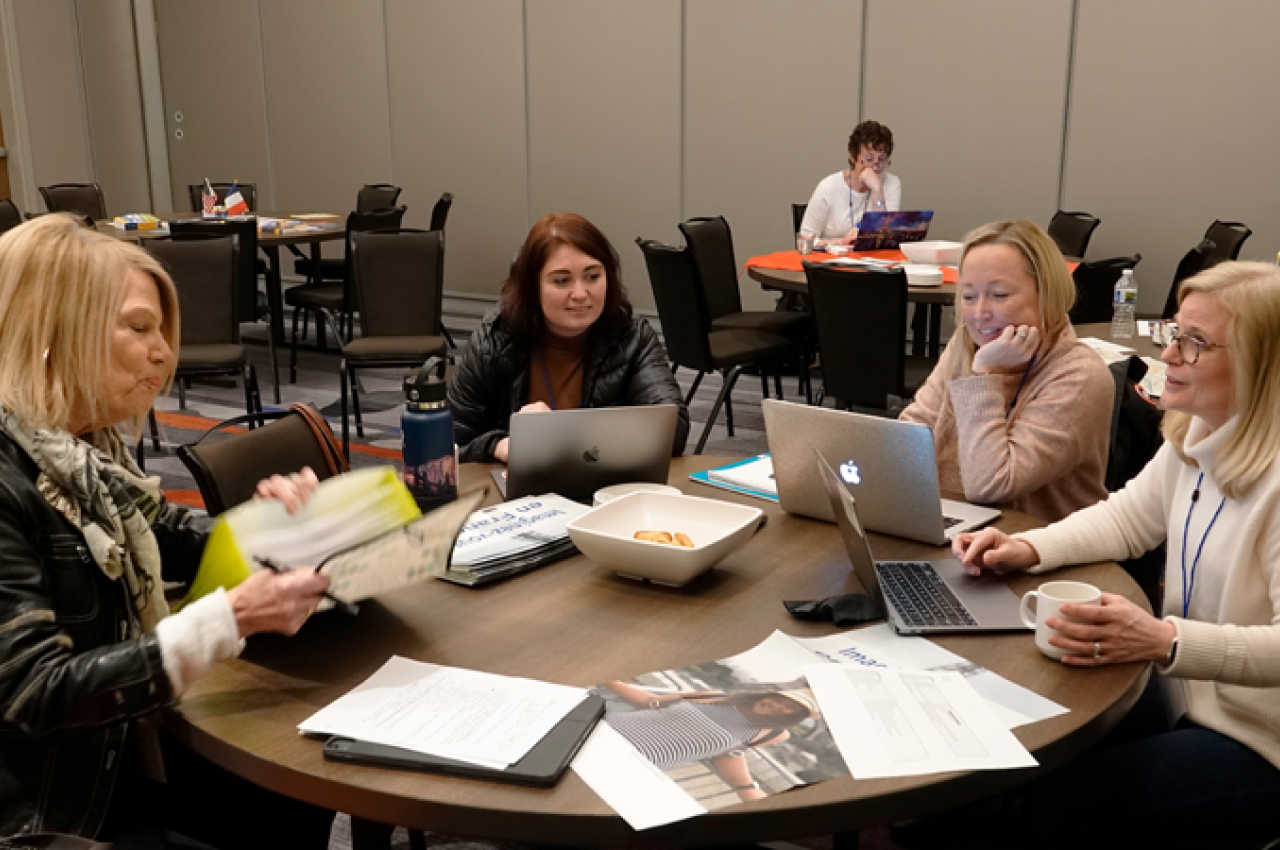 Women at a table with computers