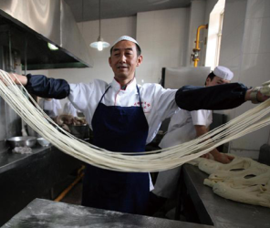 Man pulling noodles